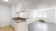 Located at 356 S Rampart Blvd in the heart of Los Angeles, this 3-bedroom, 2-bathroom unit offers a well-organized, single-floor layout designed for efficient everyday living. The galley-style kitchen features white cabinetry, granite-look countertops, a gas range, and a double basin sink, with light tile flooring lending a clean, bright feel to the space. It opens toward the living area, which is anchored by wood-look laminate flooring, a ceiling fan with light fixture, and a textured ceiling. A hallway connects the main living areas to the three bedrooms and two bathrooms, maintaining a logical and practical flow throughout. Each bedroom is finished with wood-look laminate flooring, crisp white walls, a textured ceiling, and window blinds that allow for natural light and privacy. The primary bedroom includes a sliding-door closet for added storage. Both bathrooms are finished with light tile flooring, white surrounds, and tub-shower combinations paired with white vanity cabinetry. The unit's consistent white palette and neutral finishes throughout create a clean, move-in-ready atmosphere suited for a variety of living arrangements in a central Los Angeles location.