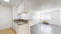 Located at 356 S Rampart Blvd in the heart of Los Angeles, this 3-bedroom, 2-bathroom unit offers a well-organized, single-floor layout designed for efficient everyday living. The galley-style kitchen features white cabinetry, granite-look countertops, a gas range, and a double basin sink, with light tile flooring lending a clean, bright feel to the space. It opens toward the living area, which is anchored by wood-look laminate flooring, a ceiling fan with light fixture, and a textured ceiling. A hallway connects the main living areas to the three bedrooms and two bathrooms, maintaining a logical and practical flow throughout. Each bedroom is finished with wood-look laminate flooring, crisp white walls, a textured ceiling, and window blinds that allow for natural light and privacy. The primary bedroom includes a sliding-door closet for added storage. Both bathrooms are finished with light tile flooring, white surrounds, and tub-shower combinations paired with white vanity cabinetry. The unit's consistent white palette and neutral finishes throughout create a clean, move-in-ready atmosphere suited for a variety of living arrangements in a central Los Angeles location.