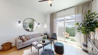 Located at 4747 N 99th Ave in Phoenix, Arizona, this well-appointed one-bedroom, one-bathroom residence offers a smart, efficient layout that maximizes every square foot. Light wood flooring flows seamlessly throughout, tying together a cohesive and contemporary aesthetic.

The combined kitchen and living area forms the heart of the home. The kitchen features two-tone cabinetry — white uppers paired with grey lowers — set against clean white countertops, stainless steel appliances, and a breakfast bar ideal for casual dining. A window above the sink brings in natural light. The adjacent living room is bright and airy, anchored by large sliding glass doors that open to a private outdoor patio, framing a verdant view and flooding the space with sunlight. A ceiling fan adds comfort overhead.

The entryway hallway is lined with framed wall art, creating a curated gallery-style passage leading into the main living space. The bedroom is a calm retreat, featuring natural light from a window with blinds, clean white walls, and ample space for furnishings. A dedicated laundry area and a well-designed bathroom — complete with a glass-enclosed shower, grey vanity, white countertop, and wood-look flooring — round out this functional and stylish home.