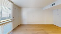 This efficiently designed 1-bedroom, 2-bathroom unit in Phoenix, AZ offers a thoughtful layout that maximizes every square foot. Throughout the space, light wood flooring creates a warm, cohesive foundation, while painted concrete block walls serve as a distinctive architectural detail, adding industrial character to an otherwise clean, modern aesthetic.

The combined kitchen and living area is anchored by a sleek peninsula with a white quartz countertop, ideal for dining or casual use. The kitchen is well-equipped with stainless steel appliances — including a gas range, microwave, dishwasher, and refrigerator — complemented by gray shaker-style cabinetry, a classic white subway tile backsplash, and recessed pendant lighting. A bold slate-blue painted brick accent wall defines the living area, highlighted by recessed lighting above.

The bedroom is a comfortable, private retreat featuring the same brick accent wall and a window that invites natural light. A dedicated closet provides practical storage. The two bathrooms are clean and functional; one features gray cabinetry with a vanity countertop, and the other includes a full tub/shower combination with brushed nickel fixtures. The unit's consistent finishes and modern updates make it a stylish and functional home in the heart of Phoenix.