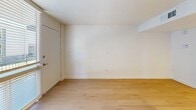 This efficiently designed 1-bedroom, 2-bathroom unit in Phoenix, AZ offers a thoughtful layout that maximizes every square foot. Throughout the space, light wood flooring creates a warm, cohesive foundation, while painted concrete block walls serve as a distinctive architectural detail, adding industrial character to an otherwise clean, modern aesthetic.

The combined kitchen and living area is anchored by a sleek peninsula with a white quartz countertop, ideal for dining or casual use. The kitchen is well-equipped with stainless steel appliances — including a gas range, microwave, dishwasher, and refrigerator — complemented by gray shaker-style cabinetry, a classic white subway tile backsplash, and recessed pendant lighting. A bold slate-blue painted brick accent wall defines the living area, highlighted by recessed lighting above.

The bedroom is a comfortable, private retreat featuring the same brick accent wall and a window that invites natural light. A dedicated closet provides practical storage. The two bathrooms are clean and functional; one features gray cabinetry with a vanity countertop, and the other includes a full tub/shower combination with brushed nickel fixtures. The unit's consistent finishes and modern updates make it a stylish and functional home in the heart of Phoenix.