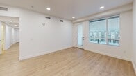 Located at 1925 W North Temple in Salt Lake City, UT, this modern 4-bedroom, 2-bathroom unit offers a well-designed, single-floor layout with contemporary finishes throughout. Light wood-tone flooring runs continuously across the living spaces, complementing the clean white walls and recessed lighting that create a bright, airy atmosphere.

The open-concept living area seamlessly connects the kitchen, dining, and living spaces. The kitchen features a large center island with a white quartz countertop and an undermount sink, rich walnut-toned cabinetry, a classic subway tile backsplash, and a full suite of stainless steel appliances including a refrigerator with ice maker, range, microwave, and dishwasher.

The four bedrooms are well-proportioned, each featuring light wood flooring, recessed lighting, and large windows with views of the surrounding neighborhood, allowing for ample natural light. The primary bedroom offers generous space and its own closet. Six closets are distributed throughout the unit, providing excellent storage.

The two bathrooms echo the modern aesthetic with walnut vanities, white quartz countertops, large mirrors, and clean white tile. One bathroom includes a full soaking tub and shower combo. Additional highlights include a private balcony accessible from the living area, an in-unit laundry room, and a connected hallway layout for easy navigation.