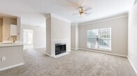 Located in Overland Park, Kansas, this well-appointed single-floor home offers three bedrooms, three bathrooms, and a thoughtfully designed layout. The open living room serves as the heart of the home, anchored by a tile-surround fireplace, crown molding, a ceiling fan, and large windows that invite abundant natural light. Soft neutral carpet and warm beige tones create a welcoming atmosphere throughout the carpeted living and bedroom areas.

The kitchen is a functional standout, featuring white shaker cabinetry, gleaming quartz countertops, a large undermount sink, and a full suite of stainless steel appliances including a refrigerator, range, microwave, and dishwasher. Wood-look flooring runs through the kitchen, adding warmth and easy maintenance.

Each of the three bedrooms offers plush carpet, natural light through blinds-equipped windows, and ceiling fans. The primary bedroom is generously sized and connects to its own bathroom. Additional bedrooms include closet access and vaulted ceiling details in select rooms. The bathrooms are finished with white vanity cabinetry, quartz counters, wood-look flooring, and tub-shower combinations. Two closets provide ample storage, and a hallway connects the spaces efficiently throughout this comfortable Overland Park residence.