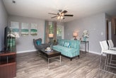 This single-story residence in McDonough, GA offers a thoughtfully designed layout with consistent finishes throughout. Rich wood-look flooring flows seamlessly across every room, anchoring the neutral gray palette that gives the home a clean, cohesive feel.

The galley-style kitchen is outfitted with white cabinetry, light stone countertops, a tile backsplash, and full appliances including a range, refrigerator, and dishwasher. It opens directly into a dedicated dining area illuminated by a pendant light, creating a natural flow for everyday living and entertaining.

The living room provides a comfortable gathering space with a window that brings in natural light. The primary bedroom is generously sized with direct access to an en-suite bathroom featuring a tub-shower combination and a granite-style vanity. A spacious walk-in closet with wire shelving offers ample storage. A second well-sized bedroom includes its own closet, and a second full bathroom with a tub-shower and matching vanity serves the rest of the home.

A dedicated in-unit laundry area houses a full-size washer and dryer, adding everyday convenience. Throughout the home, white trim and soft gray walls create a bright, welcoming ambiance suited for comfortable living in McDonough, Georgia.