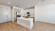 Located at 6400 County Road 124 in McKinney, TX, this thoughtfully designed one-bedroom, one-bathroom residence offers a clean, modern aesthetic across a single floor. Light wood-tone flooring flows seamlessly throughout, complementing the bright white walls and creating a warm, cohesive atmosphere.

The open-concept kitchen is a standout feature, showcasing a large center island with a white quartz countertop and an integrated sink, perfect for both meal prep and casual dining. Two-tone cabinetry pairs white upper cabinets with natural wood-grain lower cabinets, while a subway tile backsplash adds texture. Stainless steel appliances — including a French door refrigerator, range, and over-the-range microwave — complete the contemporary look. Recessed lighting illuminates the space efficiently.

The bedroom is a comfortable, well-proportioned retreat featuring a ceiling fan, a large window with horizontal blinds that invites natural light, and direct access to a dedicated closet.

The full bathroom offers a clean, functional design with a wood-toned vanity, white countertop, and a soaking tub with a tiled shower surround. Light wood flooring continues here, maintaining design consistency. A walk-in closet accessible from the bathroom provides generous storage.

Overall, this residence delivers a fresh, modern living environment with practical layouts and quality finishes throughout.