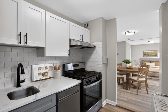 Welcome to Merrill House Apartments, where modern kitchens meet stylish living spaces. Enjoy the sleek design and functional features, perfect for your lifestyle. Elevate your home experience today—schedule a tour and find your new space! - Merrill House Apartments