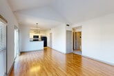 Located in the vibrant Ponce de Leon corridor of Atlanta, GA, this two-bedroom, two-bathroom residence offers a well-designed single-floor layout with a variety of appealing architectural details. The living room immediately impresses with soaring vaulted ceilings, a ceiling fan, and a large picture window topped by an arched transom that floods the space with natural light and frames views of the surrounding neighborhood. Warm hardwood flooring runs throughout the main living areas, adding a classic, polished feel.

The kitchen is thoughtfully appointed with white cabinetry, granite countertops, tile flooring, and black appliances including a refrigerator, electric range, and built-in microwave. A pendant light fixture over the peninsula adds a decorative touch. The open sightlines between the kitchen and living area create a cohesive, connected flow.

Both bedrooms are carpeted and feature ceiling fans and windows with views of greenery outside. The primary bedroom is generously proportioned and includes a walk-in closet with built-in shelving. A second closet provides additional storage convenience.

The bathrooms are clean and functional, featuring tile flooring, granite vanity tops, and a tiled tub-shower combination with a distinctive dark accent tile border. The hallway connects all rooms efficiently, completing this well-organized and comfortable Atlanta residence.