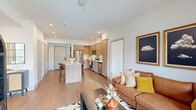 Located in Sacramento, CA, this well-designed 2-bedroom, 2-bathroom residence offers a thoughtful single-level layout with modern finishes throughout. The open-concept living area seamlessly connects the kitchen, dining, and living spaces, creating an airy and functional hub for everyday life. The kitchen is outfitted with stainless steel appliances, warm light wood cabinetry extending to the ceiling, crisp white quartz countertops, and a central island with bar seating — ideal for cooking and casual dining. Light wood-style flooring runs throughout the unit, complementing the bright white walls and recessed lighting.

The primary bedroom is generously sized, featuring large windows that invite natural light and outdoor views, a ceiling fan, and direct access to a private closet. Its en-suite bathroom includes a glass-enclosed shower, a sleek vanity with quartz countertop, and a walk-in closet. The second bedroom is equally bright with ample natural light and closet space. The second bathroom features a soaking tub with shower combination and an adjacent walk-in closet. Additional highlights include a dedicated laundry area, utility room, and hallway with three closets offering abundant storage throughout.