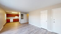 Located at 2410 Charleston Pl in Columbus, Indiana, this single-floor, 2-bedroom, 1-bathroom residence offers a practical and well-organized layout. The combined kitchen and living area serves as the heart of the home, featuring light-toned luxury vinyl plank flooring that runs throughout the entire unit. The kitchen is outfitted with warm-toned wood cabinetry, light countertops, and white appliances including a range, refrigerator, and dishwasher, alongside a pantry for added storage convenience. A large sliding glass door fitted with vertical blinds fills the living area with natural light, creating an open and airy atmosphere. Both bedrooms are comfortably sized, finished with the same wood-look flooring and neutral wall tones, and each benefits from natural light via windowed blinds. The primary bedroom includes closet access, while additional closets throughout the unit provide generous storage. A hallway connects the sleeping quarters to the full bathroom, which features tile wall surrounds, a tub-shower combination, a single-sink vanity, and wood-look flooring. A dedicated utility room and built-in shelving add further functionality to this efficiently designed home.
