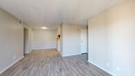 Located at 8711 Cinnamon Creek Dr in San Antonio, TX, this one-bedroom, one-bathroom single-floor unit offers a well-organized and functional layout. Light-toned luxury vinyl plank flooring runs throughout the main living areas, complemented by textured ceilings that add subtle character throughout the space.

The living room is bright and open, featuring a sliding glass door that leads to a private balcony, allowing natural light to pour in and providing outdoor views. The adjoining dining area flows naturally from the living space, supporting a cohesive open feel.

The galley-style kitchen is efficiently designed with white cabinetry, marble-look countertops, and a full suite of stainless steel appliances including a range, over-the-range microwave, refrigerator, and dishwasher. A pantry provides additional storage just off the kitchen.

The bedroom is carpeted and comfortably sized, featuring a ceiling fan, a window with natural light, and access to two closets — one of which is a spacious walk-in with wire shelving. The bathroom is clean and modern, featuring a white vanity with marble-look countertop, framed mirror, and wood-look flooring.

A dedicated laundry room houses a full-size washer and dryer, adding everyday convenience to this thoughtfully laid-out home.