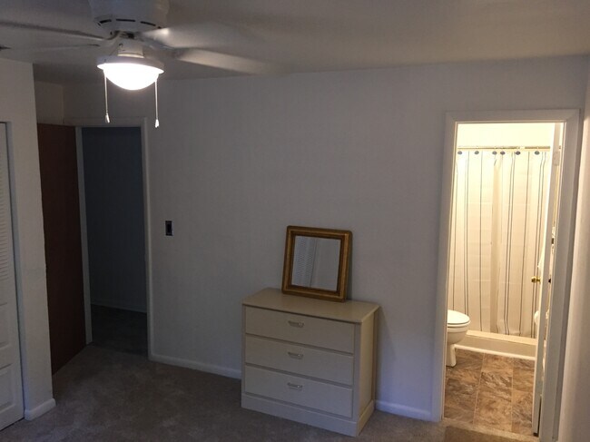 Master bedroom, taken from the corner of the room: bedroom door and closet to the to the left, bathroom to the right. (Mirror and dresser can stay if you need to use them, can go if you don’t.) - 1101 SW 20th Place