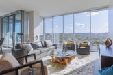 Located at 4011 Hillsboro Pike in Nashville's Green Hills neighborhood, this elegantly designed high-rise residence offers a seamless blend of modern architecture and refined living. Floor-to-ceiling glass walls flood the open-concept living and dining areas with abundant natural light while framing sweeping panoramic views of Nashville's rolling, tree-covered hills. The living room features wide-plank hardwood flooring and a sophisticated, contemporary aesthetic, while the formal dining area opens directly to a glass-railed balcony — ideal for alfresco enjoyment. The kitchen is appointed with custom white cabinetry, stainless steel double wall ovens, a stylish breakfast bar with pendant lighting, and a dedicated pantry. The spacious primary suite is carpeted and bathed in natural light, complemented by a ceiling fan and generous closet space. The luxurious primary bathroom showcases stone-clad soaking tub, a frameless glass walk-in shower with rain head, dual vanities, and tile flooring. A dedicated laundry room provides built-in cabinetry, countertop workspace, and open shelving for practical organization. Throughout the residence, a neutral palette, clean lines, and high-end finishes create a calm, polished ambiance befitting its elevated Nashville setting.