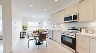 Located at 3980 Shelbourne St in Saanich, BC, this well-designed 2-bedroom, 2-bathroom unit offers a thoughtfully planned layout across a single level. The open-concept living, dining, and kitchen area forms the heart of the home, bathed in natural light from large windows that frame views of the surrounding neighbourhood. Light hardwood-style flooring flows throughout, complementing the clean, neutral palette.

The kitchen is outfitted with stainless steel appliances — including a refrigerator, electric range, over-the-range microwave, and dishwasher — paired with light wood cabinetry, white quartz countertops, and under-cabinet lighting. A compact dining area sits adjacent, making the space ideal for everyday living and entertaining.

The primary bedroom is a comfortable retreat featuring a large window with scenic views and light hardwood flooring. The second bedroom includes a sliding door closet and a dedicated workspace, offering flexibility for guests or a home office setup.

Two well-appointed bathrooms serve the unit: one featuring a glass-enclosed walk-in shower with light wood vanity, and the other with a full soaker tub and a clean white vanity. Both bathrooms echo the modern, minimalist aesthetic found throughout the unit. A hallway connects all rooms efficiently, completing this practical and stylish Saanich residence.