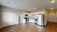 This single-floor residence in Colorado Springs, Colorado offers a thoughtfully designed layout with modern finishes throughout. The kitchen serves as a functional centerpiece, featuring white shaker-style cabinetry, granite countertops, a tile backsplash, and a full suite of stainless steel appliances including a range, over-the-range microwave, dishwasher, and refrigerator. Wood-style plank flooring runs throughout the main living areas, adding warmth and continuity to the space.

The open living area adjoins the kitchen, providing a generous, versatile space filled with recessed lighting. A sliding glass door leads to an outdoor area, while an additional window invites natural light, and a closet provides convenient built-in storage.

The bedroom is finished with plush carpeting, neutral-toned walls, and multiple windows fitted with blinds, allowing for ample natural light and a calm atmosphere. A ceiling fan adds comfort year-round.

The bathroom is well-appointed with a full soaking tub and shower combination, surrounded by large-format tile surround, wood-style flooring, and built-in shelving for added storage convenience. Clean, neutral tones carry throughout, creating a cohesive and contemporary feel across the entire space.