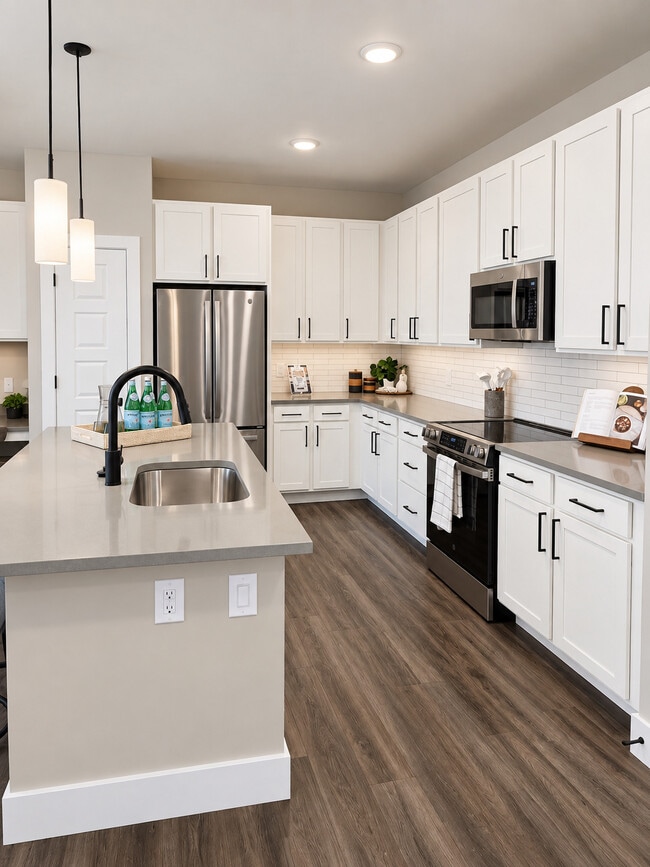 Quartz Countertops with Stainless Steel Appliances - Icon Apartment Homes at Lovell Road