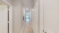 Located at 4434 Cobalt Brook Boulevard in Lutz, FL, this efficiently designed one-bedroom, one-bathroom unit offers a clean, modern aesthetic with thoughtful use of space throughout. Light wood-style flooring runs continuously across all rooms, unifying the layout and enhancing the bright, airy atmosphere created by neutral gray-white walls and recessed lighting.

The combined kitchen and living area serves as the heart of the unit. The kitchen is well-appointed with floor-to-ceiling white shaker cabinetry, light stone countertops, a stainless steel refrigerator with ice and water dispenser, a stainless steel range, built-in microwave, and a dishwasher — all providing a fully functional cooking space. The open layout allows the kitchen to flow naturally into the living area.

A wide hallway connects the main living space to the private areas of the unit, featuring high transoms above doorways that allow light to filter through. The bedroom is a comfortable, quiet retreat equipped with a ceiling fan and light fixture, neutral walls, and ample room for furnishings. A dedicated closet provides convenient storage.

The bathroom is elegantly finished with white cabinetry, a single undermount sink with brushed nickel fixtures, a backlit vanity mirror, and a walk-in glass-enclosed shower, all tied together with the same light flooring found throughout the unit.