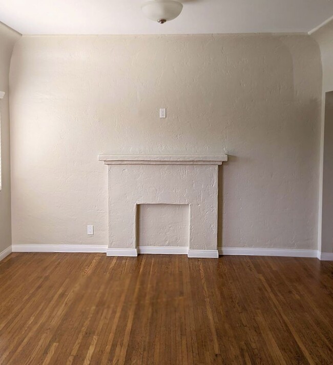 Living Room with faux mantel fireplace. - 1830 S Curson Ave