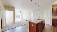 This contemporary 1120 square foot apartment in Loveland, Ohio offers a harmonious blend of comfort and functionality. The space features two bedrooms, including a primary bedroom of 200 square feet, and two full bathrooms. The open-concept design seamlessly integrates the kitchen, living, and dining areas, creating a spacious feel throughout.

The kitchen is a highlight, boasting rich wood cabinetry, granite countertops, and stainless steel appliances, including a built-in microwave. A central island with pendant lighting adds extra prep space and casual seating. The living area flows into the kitchen, with wood-look flooring creating a cohesive aesthetic.

Both bedrooms are generously sized, with plush carpeting and ample natural light from large windows. Ceiling fans in the bedrooms and living area provide additional comfort. The bathrooms feature granite vanities, wood cabinetry, and modern fixtures. A standout feature is the balcony access, offering outdoor space and views.

Additional amenities include a dedicated laundry area, a walk-in closet with wire shelving systems, and modern finishes throughout. The neutral color palette and abundance of natural light create a bright, welcoming atmosphere in this well-designed apartment.