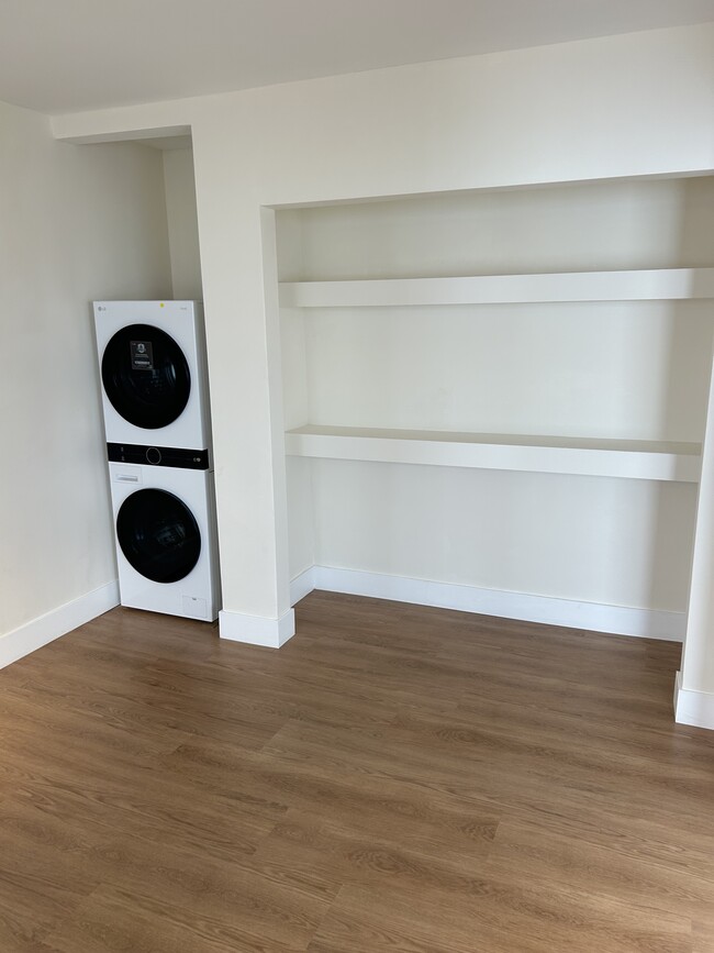 Den showing washer-dryer standing in living room looking toward kitchen. - 1137 12th St