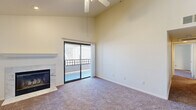 Located at 1070 Lake Front Dr in Sacramento, CA, this 2-bedroom, 2-bathroom residence offers a well-organized single-floor layout designed for comfortable everyday living. The living room is a standout space, featuring soaring vaulted ceilings, soft carpeting, and a ceiling fan that enhances the airy atmosphere. A marble-surround fireplace anchors one wall, while a sliding glass door floods the room with natural light and opens to a private balcony with outdoor views. The kitchen is efficiently designed with white cabinetry, laminate countertops, and full appliances including a refrigerator, electric range, and built-in microwave. Both bedrooms are carpeted and include ceiling fans. The primary bedroom offers generous proportions and features a mirrored sliding-door closet. The second bedroom is equally comfortable with its own closet access. Two full bathrooms each include a tub-shower combination with white tile surrounds and granite-style countertops. A dedicated laundry area houses side-by-side washer and dryer units along with an electrical panel. A hallway and closet complete this thoughtfully arranged home, making it a practical and inviting space in a lakefront Sacramento community.