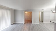 Located at 2501 Westridge St in Houston, TX, this single-story home showcases a clean, modern aesthetic achieved through thoughtful updates and a cohesive neutral color palette. Light gray wood-look flooring runs consistently throughout the home, complementing the soft gray walls and crisp white trim and baseboards found in every room.

The living areas are open and connected, with crown molding accenting the main spaces and ceiling fans providing comfort. Each room benefits from natural light through windows fitted with horizontal blinds, creating a bright and airy atmosphere. The bedrooms feature elegant paneled doors and built-in shelving, offering practical storage solutions alongside stylish details.

The kitchen stands out with granite-look countertops, gray shaker-style cabinetry, a neutral subway tile backsplash, and black appliances including a refrigerator and dishwasher — a functional and visually cohesive workspace.

The bathroom is well-appointed with a tub-shower combination surrounded by large-format tile featuring a decorative mosaic accent border, adding a refined touch to the space.

The floorplan, visible in the dollhouse view, reveals a well-organized, compact layout with clearly defined rooms and ample storage. Overall, the home presents a fresh, move-in ready environment with updated finishes that balance practicality and modern style.
