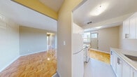 Located on the third floor at 1275 Danforth Road in Toronto's Scarborough neighbourhood, this three-bedroom, one-bathroom unit offers a practical and well-organized layout across a single floor. Consistent warm-toned parquet flooring flows throughout every room, lending a classic character to the space.

The living room is the largest area, featuring a sizeable window that fills the room with natural light and offers open views of the surrounding neighbourhood and greenery. A radiator beneath the window provides heating. Neutral-toned walls complement the light wood flooring throughout.

Each of the three bedrooms is well-proportioned, with the primary bedroom offering generous space. The bedrooms are served by connecting hallways, and several rooms feature their own windows with radiator units, ensuring both natural light and comfortable heating. One bedroom includes a double-door closet, providing practical storage. The rooms are finished with the same parquet flooring and neutral wall tones found throughout the unit.

The bathroom is clean and functional, equipped with a full soaker tub and shower combination featuring white tile surround and chrome fixtures, alongside a vanity with storage below.

Three hallways connect the rooms efficiently, contributing to a logical and easy-to-navigate floor plan. The unit's elevated position provides views of the parking area and surrounding residential landscape.