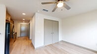 Located at 4025 Salisbury Rd in Jacksonville, FL, this efficiently designed single-floor unit offers a thoughtfully organized layout that maximizes every square foot. Light wood-style flooring flows continuously throughout the space, creating a cohesive and clean aesthetic.

The galley-style kitchen is a standout feature, outfitted with warm wood-tone cabinetry, light countertops, and a full suite of black appliances including a refrigerator, electric range, microwave, and dishwasher. Recessed lighting illuminates the space, while a window at the far end of the main room invites natural light deep into the unit.

The main room is bright and open, featuring a ceiling fan with light fixture and a set of double-door closets, providing ample storage. Clean white walls and neutral tones throughout contribute to a fresh, modern feel.

The bathroom is well-appointed with a soaking tub and shower combination, a wood-tone vanity with a white countertop and integrated sink, and light flooring that mirrors the rest of the unit. Additional functionality is provided by a dedicated laundry area and a hallway connecting the key spaces. The textured ceiling and recessed lighting add refined detail to this practical, move-in ready space.