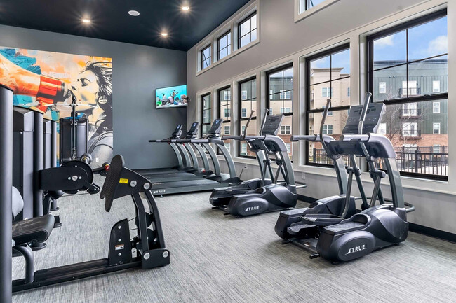 Stay fit and energized in this contemporary gym with top-notch equipment. - Colony Lofts