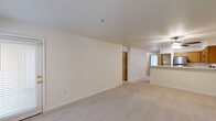 Located in Auburn, WA, this 2-bedroom, 2-bathroom residence offers a thoughtfully arranged single-floor layout with a warm, neutral palette throughout. The open living room is a standout space, featuring a classic fireplace with a white mantel, plush carpet flooring, and multiple windows that invite generous natural light and views of lush greenery. A ceiling fan adds to the room's comfort. The kitchen is well-equipped with warm oak cabinetry, white countertops, stainless steel appliances including a refrigerator, range, and dishwasher, plus a double-basin sink — all set on light hardwood-style flooring. Both bedrooms are carpeted and bright, with the second bedroom showcasing a large window with outdoor views and a baseboard heater. Each bedroom is served by its own bathroom, both featuring a full bathtub and shower combo with clean, neutral surround walls and chrome fixtures. Additional highlights include a dedicated closet for storage and a private balcony, rounding out a functional and comfortable living space suited for everyday living in the Auburn community.