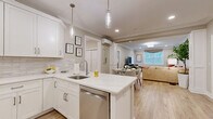 Located at 50 Mount Bethel Road in Warren, NJ, this well-appointed single-floor residence offers two bedrooms, two bathrooms, and a dedicated office across a comfortable, efficiently laid-out floor plan. The open-concept kitchen is a standout, featuring crisp white shaker cabinetry, a marble-look quartz island with bar seating, a subway tile backsplash, stainless steel appliances, and elegant pendant lighting — all flowing seamlessly into the dining and living areas. The living room is warm and inviting, with crown molding, recessed lighting, a wall-mounted mini-split system, and light hardwood flooring that extends throughout the main areas. The spacious primary bedroom provides a serene retreat with natural light, a garden view window, and ample room for a full furniture arrangement. The second bedroom mirrors this comfort with similar finishes and an outdoor-facing window. Both bathrooms are tastefully finished — the full bath features a double-sink vanity with taupe cabinetry, a soaking tub with shower, and terrazzo-style flooring. The dedicated office includes a window with natural light and its own mini-split unit, making it ideal for remote work. This residence combines modern convenience with a clean, neutral aesthetic throughout.