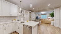 Located at 50 Mount Bethel Road in Warren, NJ, this well-appointed single-floor residence offers two bedrooms, two bathrooms, and a dedicated office across a comfortable, efficiently laid-out floor plan. The open-concept kitchen is a standout, featuring crisp white shaker cabinetry, a marble-look quartz island with bar seating, a subway tile backsplash, stainless steel appliances, and elegant pendant lighting — all flowing seamlessly into the dining and living areas. The living room is warm and inviting, with crown molding, recessed lighting, a wall-mounted mini-split system, and light hardwood flooring that extends throughout the main areas. The spacious primary bedroom provides a serene retreat with natural light, a garden view window, and ample room for a full furniture arrangement. The second bedroom mirrors this comfort with similar finishes and an outdoor-facing window. Both bathrooms are tastefully finished — the full bath features a double-sink vanity with taupe cabinetry, a soaking tub with shower, and terrazzo-style flooring. The dedicated office includes a window with natural light and its own mini-split unit, making it ideal for remote work. This residence combines modern convenience with a clean, neutral aesthetic throughout.