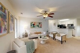 Located in Charlotte, NC, this 2-bedroom, 2-bathroom residence offers a thoughtfully organized single-floor layout that balances comfort and functionality. The open-concept living area is anchored by a carpeted living room featuring a ceiling fan with light fixture, large windows that invite natural light, and a sliding glass door leading to an outdoor balcony. The adjacent dining area provides a defined space for meals, while the kitchen is equipped with white cabinetry, stainless steel appliances, a black refrigerator, and a granite-topped breakfast bar that connects seamlessly to the dining and living spaces. Both bedrooms are carpeted and generously proportioned, with the primary bedroom benefiting from multiple windows, outdoor balcony access, and its own dedicated closet. The second bedroom is equally comfortable with its own closet for added storage. Each of the two bathrooms features a granite-topped vanity, a tub-shower combination, and hardwood-style flooring. Throughout the residence, a neutral, light color palette and textured ceilings contribute to a bright and airy ambiance. The layout flows efficiently, making the most of every area within this well-appointed Charlotte home.