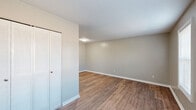 Located at 3909 Baker Plaza Dr in Columbus, Georgia, this one-bedroom, one-bathroom residence offers a practical and comfortable single-floor layout. Wood-look plank flooring flows consistently throughout the space, creating a cohesive and easy-to-maintain interior.

The galley-style kitchen is well-appointed with gray cabinetry featuring black hardware, white countertops, and stainless steel appliances including a full-size refrigerator and range. A stainless steel sink with modern faucet completes the functional workspace, providing ample storage and prep area for everyday cooking.

The spacious bedroom is a comfortable retreat, highlighted by a ceiling fan with integrated lighting and a window that allows natural light to fill the room. Neutral warm-toned walls complement the wood-look flooring, lending the room a clean, inviting atmosphere. An adjacent dedicated closet provides generous storage with a full-width hanging rod and shelf.

The bathroom features a white tiled tub and shower combination with chrome fixtures, alongside a toilet, maintaining a clean and straightforward design. Throughout the residence, consistent neutral paint tones, white baseboards, and warm flooring unify each room into a cohesive, move-in-ready living space.