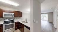 Located at 1720 Old St. Marks Church Rd in Burlington, NC, this single-floor residence offers a well-designed layout that maximizes functionality across one bedroom, one bathroom, and a variety of dedicated spaces including an office, laundry room, and four closets.

The open-concept living area seamlessly connects the dining room, kitchen, and living room. The kitchen is a standout feature, equipped with rich dark-wood cabinetry, stainless steel appliances including a range, microwave, and dishwasher, granite-style countertops, a mosaic tile backsplash, and a breakfast bar with pendant lighting overhead. Wood-style flooring flows throughout the main living and kitchen areas, adding warmth and continuity.

The generously sized primary bedroom is carpeted for comfort, features a ceiling fan with light fixture, and provides access to multiple closets. Natural light enters through windows dressed with blinds, creating a bright and airy atmosphere. Additional rooms finished in neutral tones with wood-style flooring include a versatile office space and a dedicated dining area. Crisp white trim and baseboards throughout lend a clean, polished look. The textured ceilings add a classic finishing touch to this practical and comfortable Burlington residence.