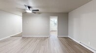 Located at 7645 Pacific Ave in Tacoma, WA, this well-appointed 2-bedroom, 2-bathroom single-floor home offers a comfortable and functional layout. The living room serves as the heart of the home, highlighted by a striking floor-to-ceiling brick fireplace, light wood-style flooring, a ceiling fan, and a baseboard heating system. Natural light filters in through multiple windows, enhancing the open and airy feel of the space.

The galley-style kitchen is thoughtfully designed with gray shaker cabinetry, marble-style countertops, and stainless steel appliances including a refrigerator, electric range, and dishwasher. Light wood flooring continues throughout, and a window above the sink brings in additional natural light.

The spacious primary bedroom features plush carpeting, a ceiling fan, and an en-suite bathroom with a dual-sink vanity, gray cabinetry, and closet storage. The second bedroom is equally well-sized, offering carpeted floors, a ceiling fan, a closet, and a window with natural light. A second full bathroom includes a tub/shower combo, vanity with storage, and wood-style flooring.

With three closets throughout and a clean, neutral color palette, this home provides practical storage and a move-in-ready aesthetic.
