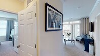 This thoughtfully designed single-floor residence offers a comfortable and cohesive living experience across a well-organized layout. The inviting entryway, accented with crown molding and neutral tones, leads into a bright and open living area finished with plush carpeting and crown molding. Large sliding glass doors flood the space with natural light and open directly onto a private balcony, offering pleasant views of the surrounding neighborhood. The living room provides ample space for relaxed seating arrangements. Adjacent to the living area, the dining space is framed by expansive windows on multiple sides, creating a light-filled setting ideal for entertaining. The kitchen features warm wood cabinetry, granite countertops, stainless steel appliances, and tile flooring, combining functionality with a clean aesthetic. Both bedrooms are carpeted and generously sized, each benefiting from natural light through large windows with views to the exterior. The two bathrooms are well-finished, one offering a tiled tub-shower combination with a wide vanity, and the other a clean, functional design with tile flooring and a wood vanity. Throughout the residence, neutral warm tones and consistent finishes create a harmonious and welcoming ambiance.