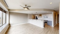 Located at 217 Second St NW in Canton, Ohio, this thoughtfully designed 1-bedroom, 2-bathroom unit offers a well-appointed single-floor layout with contemporary finishes throughout. The open-concept living and kitchen area forms the heart of the unit, anchored by light-toned luxury vinyl plank flooring and a modern ceiling fan that adds both function and style. The kitchen is a standout feature, showcasing granite countertops, white upper cabinetry paired with dark lower cabinets, a classic white subway tile backsplash, and a full suite of stainless steel appliances including a refrigerator, range, and microwave. A spacious peninsula with bar seating and elegant pendant lighting creates an inviting space for dining or entertaining. The living area is open and airy, with recessed lighting and neutral warm-toned walls providing a versatile backdrop. A clean hallway with continued vinyl plank flooring connects the main living space to the private bedroom and bathrooms. The generously sized primary bedroom features plush carpeting, a ceiling fan, and a window for natural light. The bathrooms are finished with tile flooring and include a walk-in shower. This unit offers a cohesive, modern aesthetic with practical details throughout.