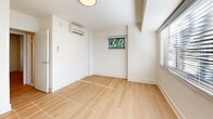 Located at 3201 Wisconsin Ave NW in Washington, DC's desirable upper Northwest corridor, Unit 201 is a well-appointed residence designed with clean lines and a bright, neutral aesthetic throughout. Light-toned hardwood flooring flows seamlessly across the living areas and bedrooms, complementing the crisp white walls and creating a cohesive, airy atmosphere. Multiple rooms feature wide windows dressed with horizontal blinds, inviting generous natural light and offering views of surrounding greenery. The open living area is equipped with a wall-mounted mini-split system for efficient climate control. The galley-style kitchen is outfitted with white shaker cabinetry, quartz countertops, a subway tile backsplash, stainless steel appliances including a gas range and refrigerator, and recessed lighting overhead. The bathroom features large-format travertine tile flooring, a soaking tub with white tile surround, a vanity with storage, and a natural light source via a frosted window. A dedicated laundry closet houses a stacked front-loading washer and dryer alongside built-in shelving for additional storage. The overall layout is practical and well-organized, offering comfortable living in a prime Washington, DC location.
