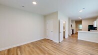 Located at 833 E Davis St in Sullivan, Indiana, this two-story home offers three bedrooms, three bathrooms, and a practical, well-organized layout across two floors. The main level features an open living area with light-toned luxury vinyl plank flooring that runs throughout, recessed lighting, and neutral walls that create a bright, clean atmosphere. The kitchen is equipped with white shaker-style cabinetry, a marble-look peninsula countertop, a stainless sink, and a black refrigerator, opening naturally toward the living and dining areas. Multiple windows on this level invite natural light and offer views of the surrounding greenery. A dedicated laundry room on the main floor houses a full-size GE washer and dryer with overhead shelving for added storage. The main level also includes a full bathroom with gray cabinetry and a clean, modern finish. Upstairs, the second floor hosts the remaining bedrooms, including a generously sized primary bedroom, all carpeted for comfort. Each bedroom features windows overlooking outdoor greenery, and closets provide ample storage. Additional hallways and four total closets throughout the home ensure practical organization. With a utility room and thoughtful floor plan, this home delivers functional living across every level.