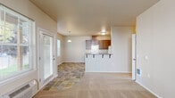 Located at 1124 McGee Ct NE in Salem, Oregon, this single-floor, 2-bedroom, 3-bathroom home offers a practical and comfortable layout designed for everyday living. The open-concept living and kitchen area serves as the heart of the home, where warm wood cabinetry, a breakfast bar with seating, and white appliances — including a range, refrigerator, and dishwasher — come together in a well-appointed galley-style kitchen. Durable tile flooring flows through the kitchen and dining space, transitioning to plush carpet in the living area, creating a welcoming atmosphere. A sliding glass door brings in natural light and provides outdoor access. Each bedroom is carpeted and includes a closet with a hanging rod, offering practical storage. The primary bedroom features vaulted ceilings that lend an open, airy feel. The bathrooms are clean and functional, with one featuring a full soaking tub and shower surround with brushed nickel fixtures, and another with a wood-cabinet vanity topped with a light countertop and a framed mirror. Neutral warm tones throughout the home create a cohesive, calm ambiance, making it a comfortable and move-in-ready residence.