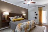 Located at 30000 FM-2978 in Magnolia, TX, this single-story residence offers a thoughtfully designed layout with a variety of well-appointed living spaces. The living room features rich hardwood flooring, crown molding, a ceiling fan, and large windows that invite natural light and provide views of the surrounding neighborhood. Adjacent to the living area, the dining room continues the hardwood flooring and is illuminated by stylish track lighting, creating a warm and inviting atmosphere for gatherings. The kitchen is a standout feature, showcasing dark espresso cabinetry, granite countertops, a tile backsplash, stainless steel appliances, and a peninsula with a deep double sink — all finished with track lighting and crown molding. The primary bedroom offers hardwood floors, crown molding, direct outdoor access, and a spacious walk-in closet, while additional bedrooms are carpeted and include ceiling fans and ample closet space. A dedicated home office with carpet and a ceiling fan provides a quiet workspace. Bathrooms include a full bath with a granite-topped dark wood vanity and tiled tub-shower combo, as well as a separate shower enclosure finished in large-format stone-look tile with chrome fixtures. Throughout, neutral tones and quality finishes create a cohesive, comfortable living environment.