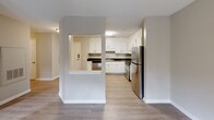 Located at 1030 Atlas Rd in Columbia, SC, this single-floor, 2-bedroom, 1-bathroom home offers a thoughtfully designed layout that makes efficient use of its space. The kitchen is a standout feature, boasting crisp white shaker-style cabinetry, dark countertops, light wood-look luxury vinyl flooring, and a full suite of stainless steel appliances including a refrigerator, range, dishwasher, and built-in microwave hood. A pass-through peninsula connects the kitchen to the adjoining living area, enhancing the open flow of the home.

Both bedrooms are carpeted and painted in neutral tones, lending a calm and comfortable atmosphere. The primary bedroom is generously sized, featuring a ceiling fan with light fixture, dual windows that invite natural light and greenery views, and convenient access to a dedicated closet. The second bedroom also offers carpet flooring, a ceiling fan, and its own window with outdoor views.

The bathroom is functionally designed with light wood-look flooring, a combined tub and shower, and accessibility-friendly grab bars installed along the walls. Classic six-panel interior doors are found throughout the home, complemented by clean white trim and neutral wall colors that create a cohesive, move-in-ready aesthetic throughout.
