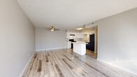 Located at 2350 E Water St in Tucson, AZ, this 2-bedroom, 2-bathroom single-floor unit offers a well-organized layout with a comfortable, functional design throughout. The open-concept living and kitchen area serves as the heart of the home, featuring light wood-look flooring, a textured ceiling, and a ceiling fan that keeps the space airy. Large windows allow generous natural light to pour in, brightening the entire common area. The kitchen is outfitted with white cabinetry, granite-look countertops, black appliances including a range, dishwasher, and refrigerator, and a central island that provides additional prep and seating space. Both bedrooms are carpeted and showcase a distinctive painted white brick accent wall, adding character and texture to each room. The primary bedroom is generously sized, featuring an arched window, a ceiling fan, and access to a walk-in closet. The second bedroom also offers a ceiling fan and a large window with natural light. Each bathroom has a clean, modern finish — one featuring a tub/shower combo and the other a dedicated shower stall — both with light wood-look flooring. A dedicated laundry area and three closets round out the practical amenities of this well-appointed Tucson residence.