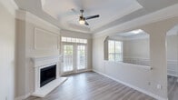 Located in Dallas, TX, this well-appointed 2-bedroom, 2-bathroom residence offers a thoughtfully designed single-floor layout with modern finishes throughout. The living room serves as the centerpiece of the home, highlighted by a striking tray ceiling, a ceiling fan, a classic white fireplace, and French doors that flood the space with natural light and provide access to the balcony. Light-toned hardwood-style flooring runs throughout, contributing to a clean, cohesive aesthetic. The open-concept kitchen is equipped with white shaker cabinetry, a subway tile backsplash, stainless steel appliances, and a large island with dark countertops and a built-in sink — ideal for both cooking and casual dining. A dedicated dining room and connected living areas enhance the flow of the home. Both bedrooms are generously sized, each featuring a ceiling fan and large windows with outdoor views. Spacious walk-in closets with wire shelving provide ample storage. The two bathrooms are finished with white cabinetry, dark countertops, and include a shower-tub combo. Additional features include an entrance, hallway, laundry room, utility room, and both a balcony and a patio, offering comfortable indoor-outdoor living.