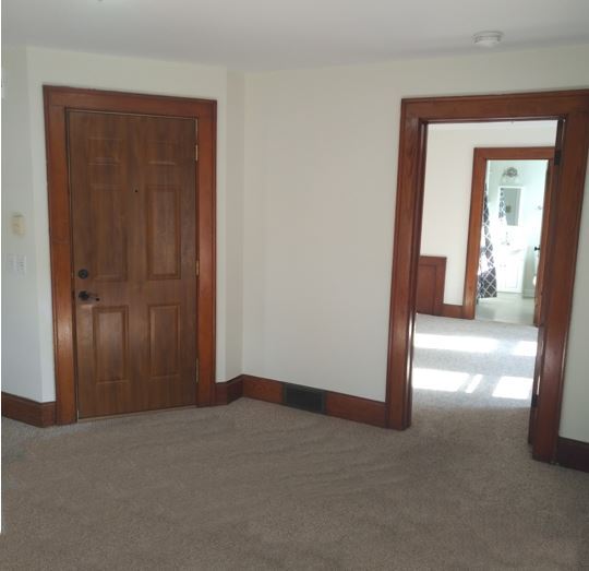 Living room with original woodwork and large bedroom - 305 2nd Ave