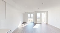 This contemporary single-floor residence showcases a clean, modern design throughout. The open-concept layout connects the living area to the kitchen, creating a cohesive and functional space. Wood-look plank flooring runs continuously throughout, complementing the crisp white walls and adding warmth to the overall aesthetic.

The kitchen is well-appointed with stainless steel appliances, including a refrigerator, electric range, and over-the-range microwave. Two-toned cabinetry pairs white upper cabinets with light wood lower cabinets, accented by white quartz countertops and a subtle vertical tile backsplash. A stainless steel sink completes the space.

The living area is generously proportioned and bathed in natural light from large floor-to-ceiling windows, which frame elevated views of the surrounding cityscape and palm trees. A private balcony is accessible directly from the living space, extending the indoor-outdoor connection.

The bedroom offers ample space with a large window providing additional city views and a well-organized reach-in closet with built-in shelving and hanging rods. A second closet is also present near the entry.

The bathroom features a soaking tub with a shower, finished with light gray large-format tile surround and brushed nickel fixtures, maintaining the unit's consistent modern palette.