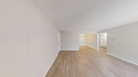 This 570 square foot apartment in Indianapolis offers a thoughtful layout maximizing space efficiency. The open-concept living area features a large sliding glass door, flooding the room with natural light and providing outdoor access. Modern vinyl plank flooring runs throughout, complementing the neutral color scheme.

The kitchen, while compact, is well-equipped with wooden cabinetry, a double sink, and black appliances, including a full-size refrigerator and range. The bathroom is functional, featuring a shower/tub combination and a simple vanity.

The primary bedroom, measuring 130 square feet, offers ample space for a queen-sized bed and includes a window with horizontal blinds. The second bedroom, though smaller, can comfortably accommodate a single bed or serve as a home office.

Storage solutions include a walk-in closet with wire shelving, ensuring ample space for personal belongings. The apartment's single-floor layout and neutral palette provide a blank canvas for personalization, making it suitable for various lifestyle needs.