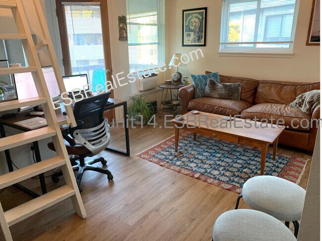Lounge area with door to south/south-west facing deck. End unit so windows both south and west. - 1830 22nd St