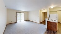 Located at 2311 Massillon St in Findlay, Ohio, this 2-bedroom, 2-bathroom single-floor residence offers a practical and well-organized layout. The open kitchen and living area serves as the heart of the home, where durable wood-look flooring runs underfoot. The kitchen is equipped with warm oak cabinetry, a coil-burner electric range, a full-size refrigerator, and a stainless steel sink, with a breakfast bar peninsula that connects seamlessly to the living space. The living room is generously proportioned, featuring plush carpeting and a sliding glass door that lets in natural light and provides outdoor access. Both bedrooms are carpeted and offer a comfortable, quiet retreat. The primary bedroom includes a ceiling fan with light fixture and a double-door closet, while the second bedroom also features a ceiling fan, a closet, and a window with outdoor views. Each bathroom is finished with oak vanity cabinetry, a mirrored medicine cabinet, wood-look flooring, and brushed nickel fixtures. A connecting hallway provides smooth flow between the living areas and bedrooms. Warm wood trim accents and neutral wall tones carry throughout, giving the entire space a cohesive and inviting character.