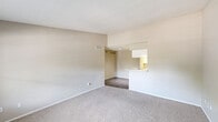 Located at 8300 Sands Point Dr in Houston, TX, this 2-bedroom, 1-bathroom unit offers a functional single-story layout with a thoughtful mix of flooring and finishes throughout. The combined kitchen and living area serves as the heart of the home, with the kitchen featuring a galley-style design complete with white cabinetry, marble-look countertops, white appliances including an electric range and refrigerator, and wood-look vinyl flooring. A peninsula counter connects the kitchen to the living space, creating an open and accessible flow. The living room is carpeted and receives natural light through a window overlooking a greenery-filled exterior. Both bedrooms are carpeted and offer neutral wall tones, with windows that bring in natural light and views of the surrounding landscape. The primary bedroom includes a dedicated closet and direct access to the full bathroom. The bathroom is equipped with a full tub-shower combination featuring white tile surround. A hallway connects the private areas of the unit, keeping the layout organized and efficient. The space presents a clean, move-in ready aesthetic with a neutral color palette throughout.